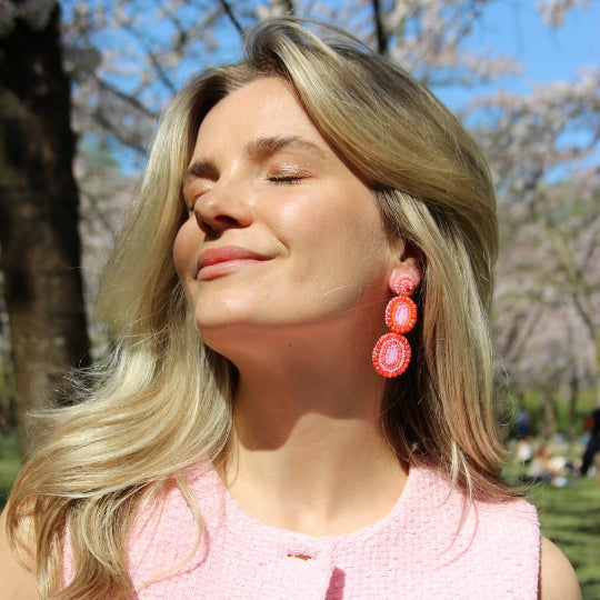 Ella Shine Earrings - Pink Orange - Model - Paulie Pocket